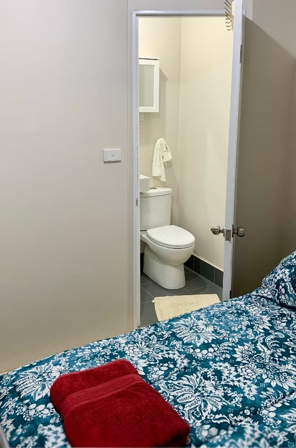 Looking across the master bedroom’s queen bed, into the refurbished ensuite.