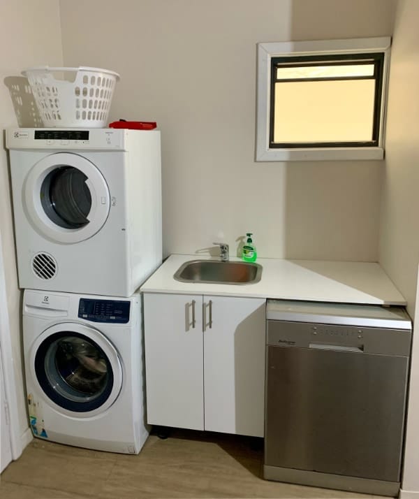 The laundry area features a wash basin, washing machine, tumble dryer, and a dishwasher.